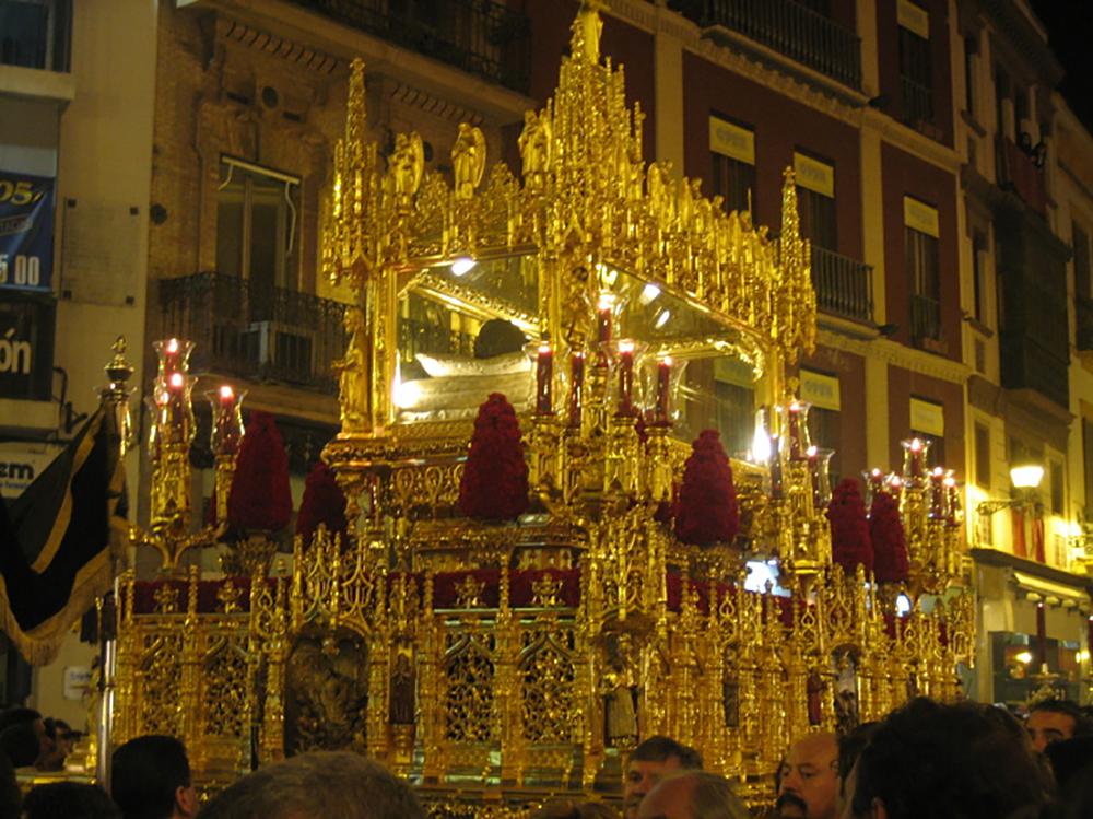 Nazarenos de la Cofradía del Calvario de Sevilla durante la Semana Santa, vestidos con túnicas oscuras.