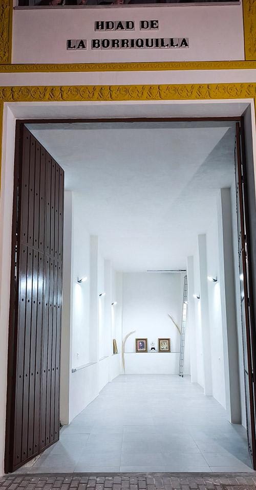 Interior blanco y alargado de la nueva Casa de Hermandad, visto desde su entrada.