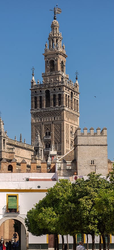La Giralda de Sevilla vista desde abajo, con detalle de sus paños y del cuerpo superior del campanario.